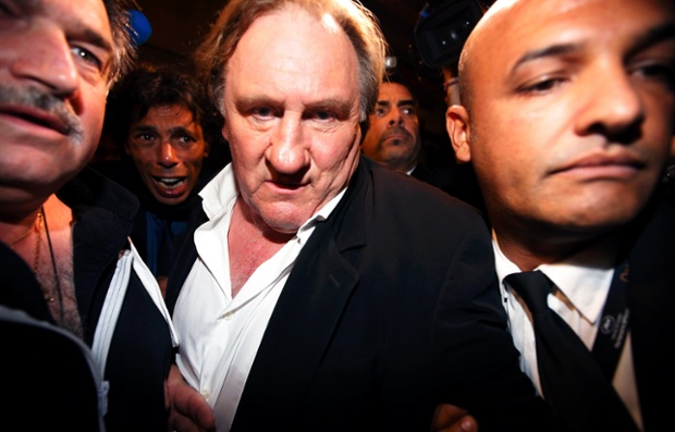Cannes, France: Gerard Depardieu is surrounded by bodyguards as he leaves the screening of the film Welcome to New York at the Cannes film festival.