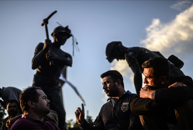 Soma, Turkey: Miners talk in front a statue four days after a mine explosion in the area which killed 301 colleagues.