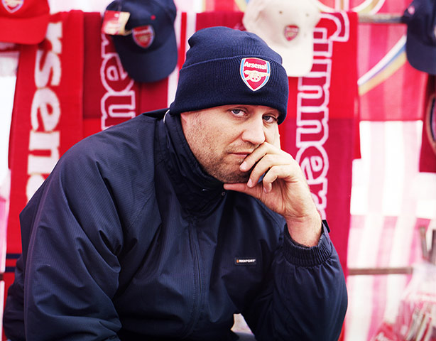 Arsenal fans: An unhappy looking stall holder
