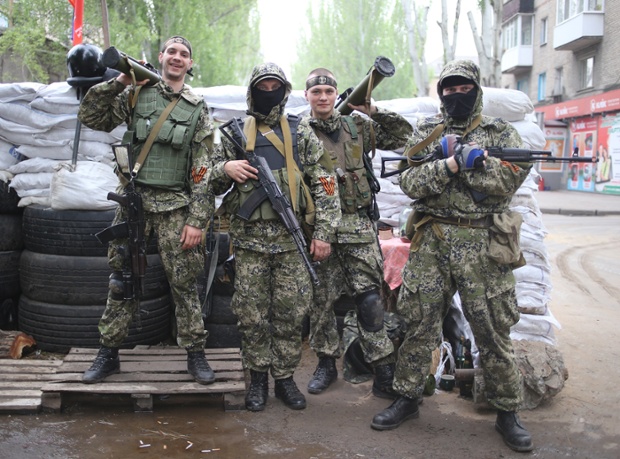 Members of pro Russian self-defense militia pose for a group photograph in a street of Slavyansk.