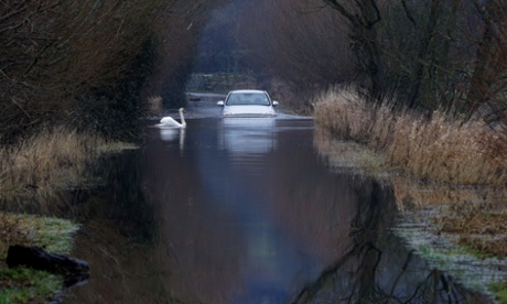 A car drives through flood water on the Somerset Levels on January 29, 2014 near Langport in Somerset.