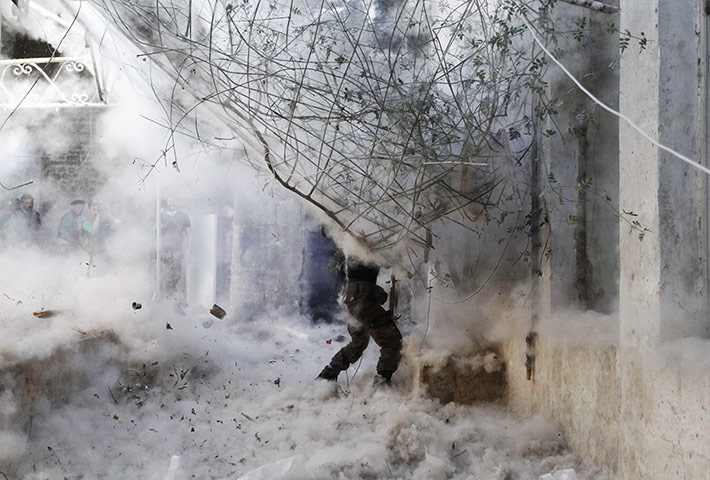 20 Photos: A Free Syrian Army fighter fires a rocket-propelled grenade in Aleppo