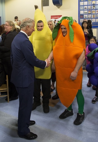 He looks a right banana - the man in the costume that is. Prince Charles and Camilla visit the Military Families Resources centre in Halifax, Canada during a tour of the country.