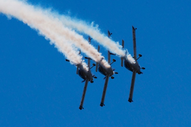 The WeFly Team flies in formation in Fly Synthesis Texan Top Class planes during the opening of the Air Show.