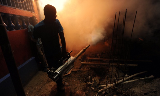 Workers from Haiti's Ministry of Public Health and Population spray chemicals to exterminate mosquitoes in Port-au-Princeo to help prevent chikungunya, dengue, malaria and filariose.