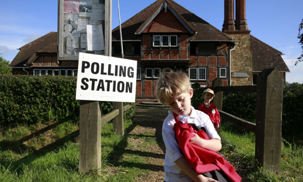 Too young to vote...schoolchildren walk past the local and european election polling station at Rotherwick Village Hall near Hartley Wintney