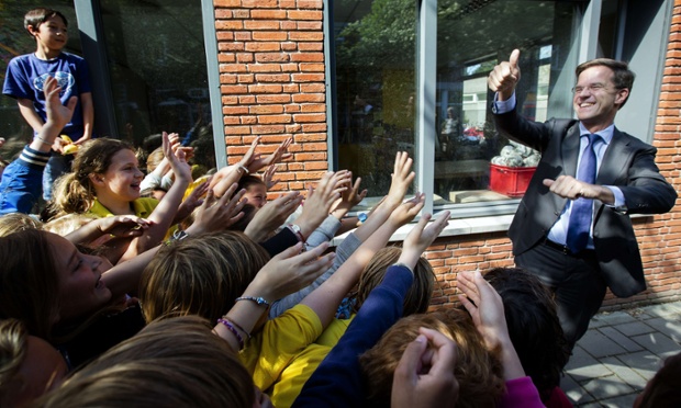 Dutch Prime minister Mark Rutte greets schoolchildren after voting in the European election at the De Wolters primary school in The Hague.