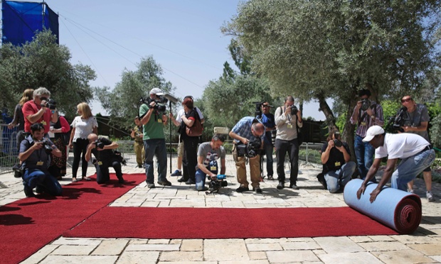 Rolling out the red carpet... Israeli media at the Israeli president's residence in preparation for the Pope's visit on Saturday to Jerusalem.