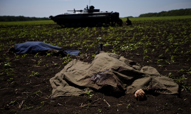 Bodies covered with blankets lie in a field near the village of Blahodatne, after at least 11 Ukrainian troops were killed and 30 others were wounded when Pro-Russians attacked a military checkpoint, the deadliest raid in the weeks of fighting in eastern Ukraine.