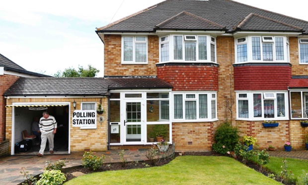 A man leaves after casting his vote in a polling station set up in a residential garage in Croydon.