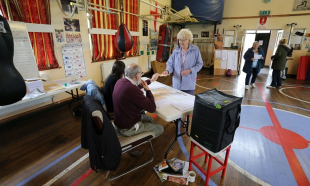 Local residents cast their votes at a polling station in the East Hull Boxing Club in Kingston-Upon-Hull.