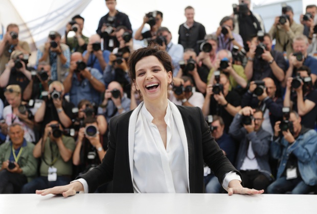 Actress Juliette Binoche laughs as she poses for photographers during a photo call for Sils Maria at the 67th international film festival, Cannes, southern France.