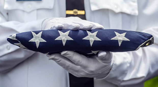 A Stanford honour guard member holds the American flag at the Veterans Memorial Garden at Preston Pruitt Funeral Hone in Danville, Kentucky.