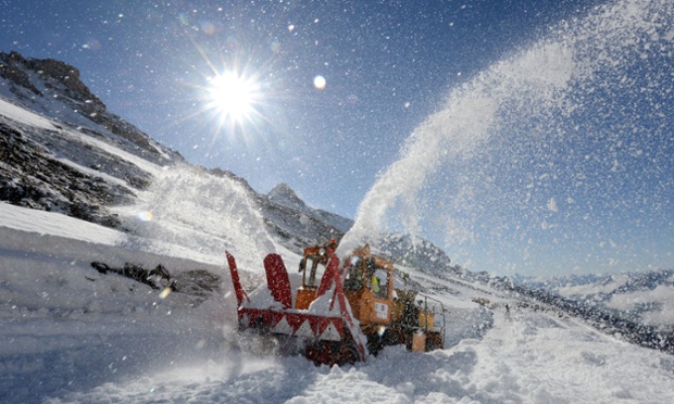 A person uses a snow thrower to evacuate snow from the Galibier pass, in the Hautes-Alpes, 2,700 m of elevation, to open the road linking the department of Savoie to the Hautes-Alpes, in Villar-d'Arene, on May 22, 2014. The road will officially open on May 28, 2014.   AFP PHOTO/JEAN-PIERRE CLATOTJEAN-PIERRE CLATOT/AFP/Getty Images