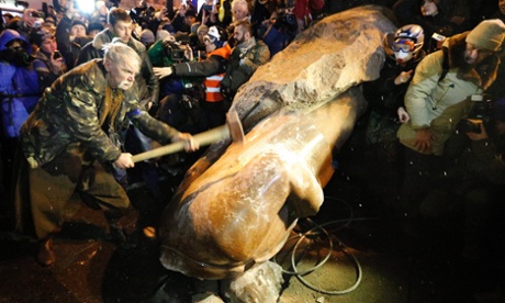 A protester hammers at a toppled statue of former Soviet leader Vladimir Lenin during a pro-European protest in December 2013.