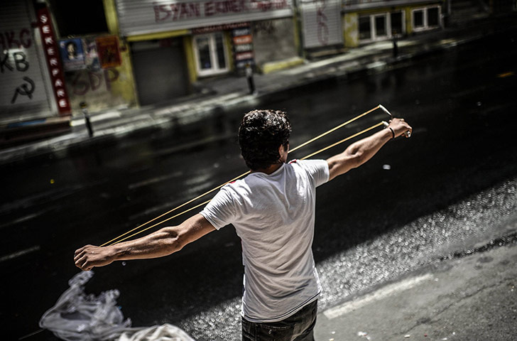 20 Photos: A young protester uses a sling-shot as h