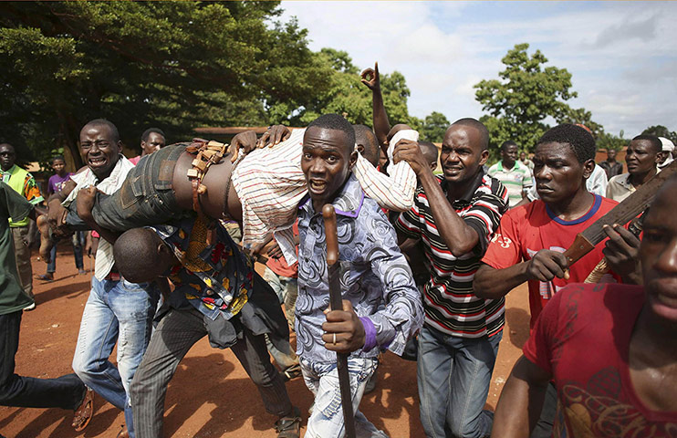 20 Photos: Protesters carry a man who was shot by French soldiers in Bambari
