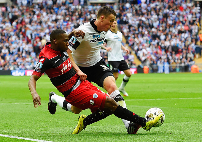 Play Off: QPR's Junior Hoilett and Craig Forsyth of Derby challenge for the ball