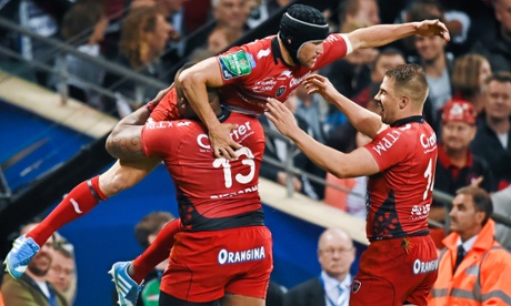 Matt Giteau, top, is congratulated by his Toulon team-mates after scoring a try.