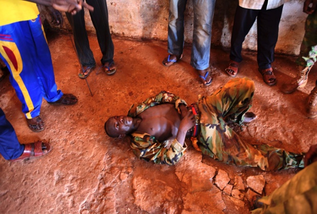 An injured Seleka fighter lies on the ground in Bambari, Central African Republic.