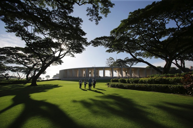 American veterans and their companions walk towards a memorial during US Memorial Day ceremonies at the Manila American Cemetery and Memorial in Taguig, Philippines.