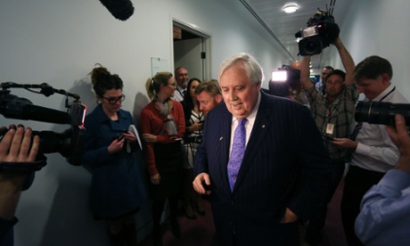 Leader of the Palmer United party Clive Palmer speaks to the media in the press gallery with Bridie Jabour lurking to the left.