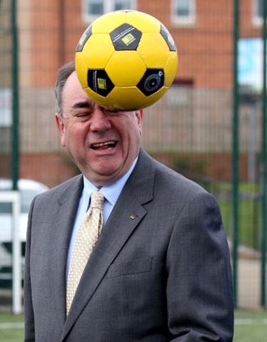 Scotland's First Minister Alex Salmond   heads a ball 