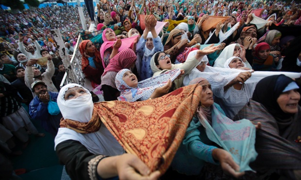 Kashmiri Muslims pray as a head priest, unseen, displays a holy relic believed to be the hair from the beard of Prophet Mohammed, on Mehraj-u-Alam at the Hazratbal Shrine on the outskirts of Srinagar, India, Tuesday, May 27, 2014. Thousands of devotees thronged the Hazratbal shrine during Mehraj-u-Alam, believed to mark the ascension of Prophet Mohammed to Heaven. (AP Photo/Mukhtar Khan) plg