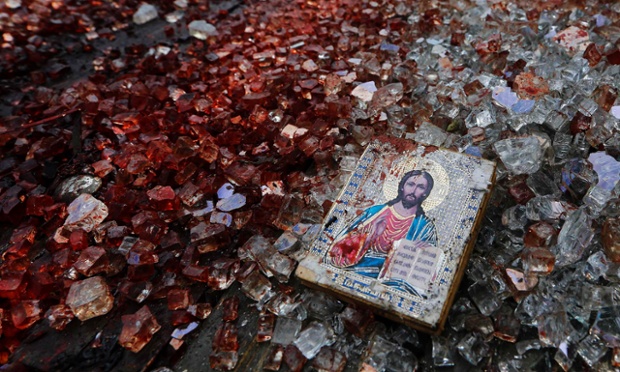 A bloodstained icon of Jesus is seen among shattered glass atop a wrecked Kamaz truck near the Donetsk airport May 27, 2014. Ukrainian forces fought with separatists in the city of Donetsk for a second day on Tuesday after inflicting heavy losses on the rebels while the government vowed to press on with a military offensive 