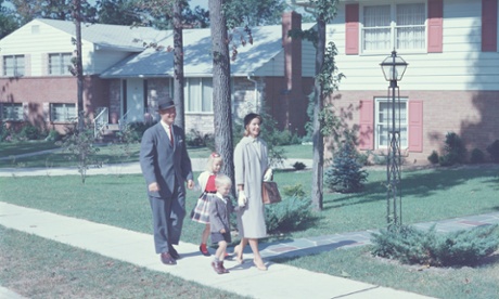 Family on suburban street in 1950s
