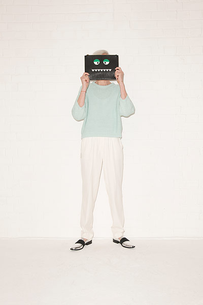 All Ages green: green jumper white trousers silver black flat shoes