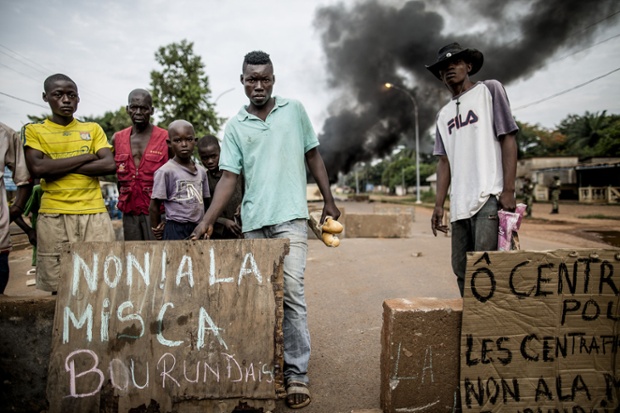 People protest following an attack on a church in central Bangui, Central African Republic. At least 15 people, including a priest, were killed and several others wounded in clashes.
