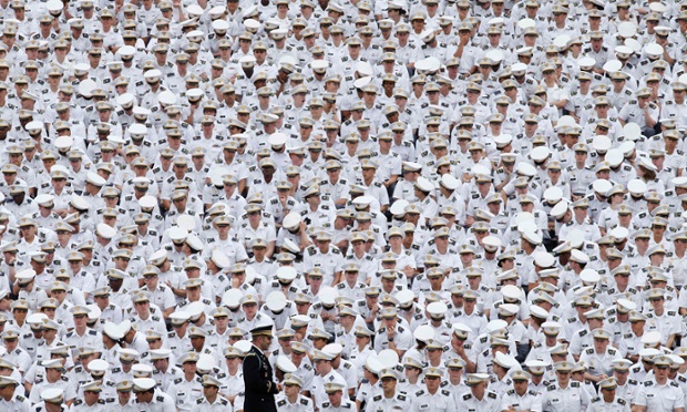 Underclassmen listen from the back of the stadium as President Barack Obama speaks at a commencement ceremony at the United States Military Academy at West Point, New York.