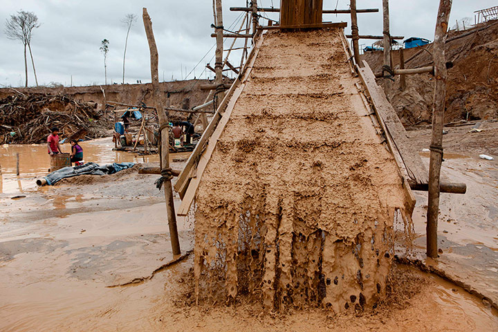 Illegal gold mining: Water streams over carpets that filter the earth and water