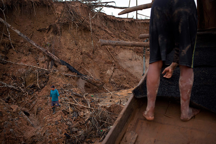 Illegal gold mining: A miner walks amid the destruction of the jungle