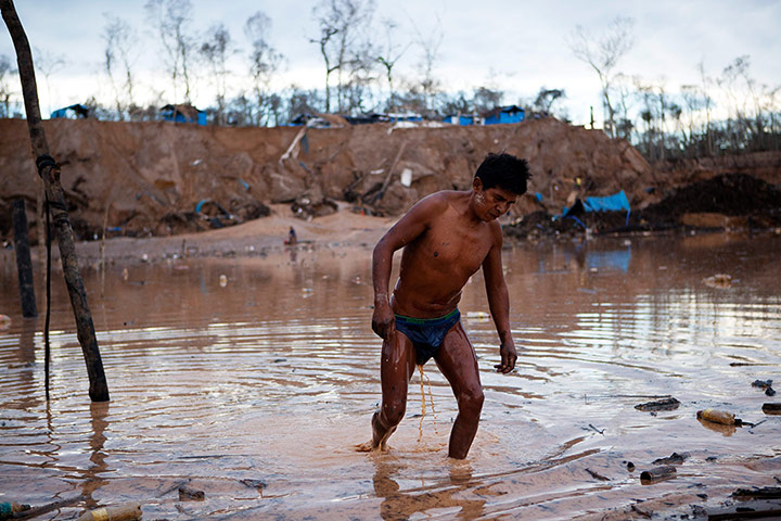 Illegal gold mining: A miner leaves an area where water is pumped