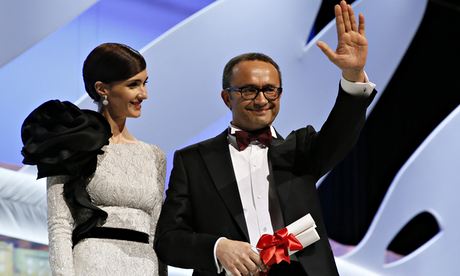 Leviathan director Andrey Zvyagintsev collects his prize from Paz Vega at Cannes on 24 May