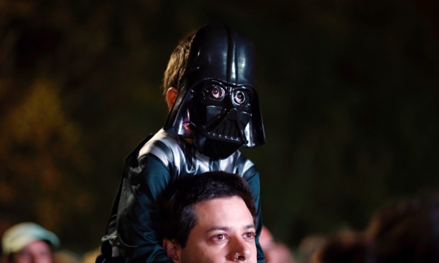 Buenos Aires, Argentina: A boy wears a Darth Vader mask as he sits on his father's shoulders before a Star Wars-themed race.