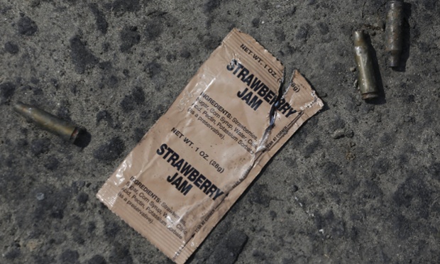 Kramatorsk, Ukraine: A used packet of the US Army soldier's ration and used AK shells lie on a ground at a checkpoint.
