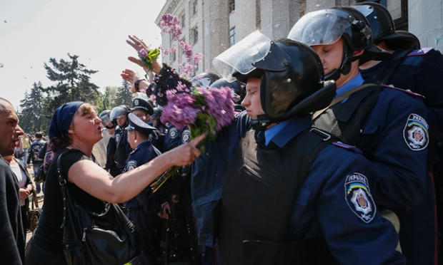 Odessa, Ukraine: A woman attacks members of the Ukrainian Interior Ministry security forces with flowers during a rally outside a trade union building.