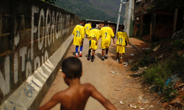 Rio de Janeiro, Brazil: Children of Nova Geracao (New Generation) team leave the field after losing a match during a local tournament at the Borel slum.