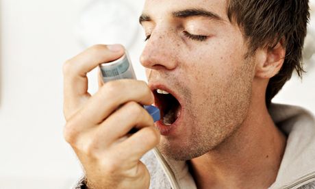 Man using an asthma inhaler