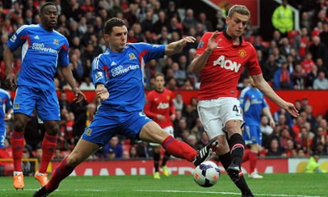 Hull's Alex Bruce, centre, tries to block a shot from Manchester United debutant James Wilson.
