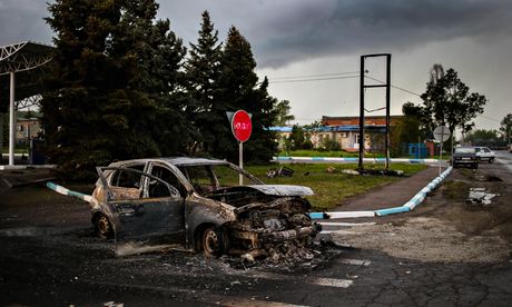 A burned down car parked on a road near Slavyansk.