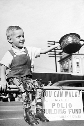 David Henseley, young American child crippled by polio with both legs in braces, soliciting funds in public fund-raising driver for a new polio hospital. David Henseley, young child crippled by polio with both legs in braces, soliciting funds in public fund-raising driver for a new polio hospital. Black and white photo, sign reads 