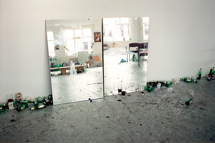 Wolfgang Tillmans: mirror in room full of party debris bottles cans cups