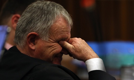 Oscar Pistorius' lawyer Barry Roux covers his face during the testimony of defence ballistics expert Tom Wolmarans on Friday.