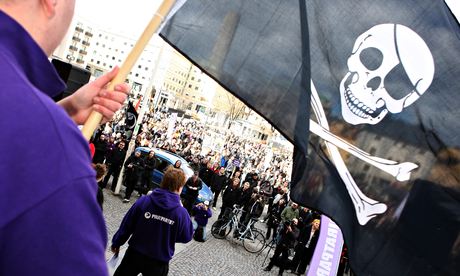 A supporter of filesharing hub The Pirate Bay, waves a Jolly Roger flag during a demo in Sweden