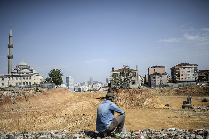 20 Photos: A man looks at a lone house at a construction site in Fikirtepe, Istanbul