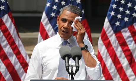 President Barack Obama wiping perspiration from his face as he speaks about climate change at Georgetown University in Washington.